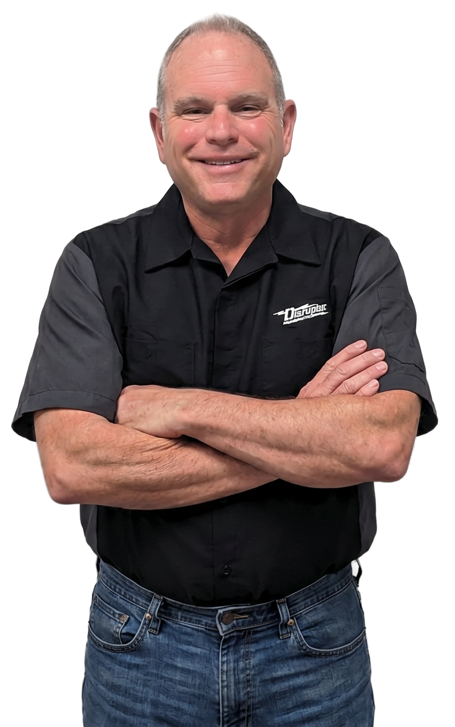 Smiling middle-aged man with arms crossed, wearing a black short-sleeve shirt and blue jeans, white background, logo on shirt pocket.